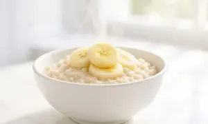 Una ciotola di porridge caldo con fette di banana. Attenzione: il porridge senza cottura fa male.