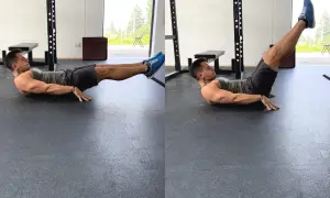 Uomo esegue crunch a gambe tese, uno dei migliori esercizi addominali per scolpire il core.