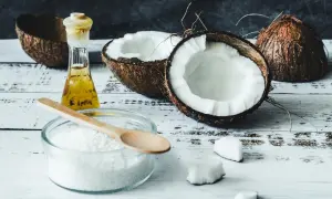 Scopri come usare olio di cocco in cucina: cocco fresco, olio dorato e farina bianca pronti per creare piatti esotici.