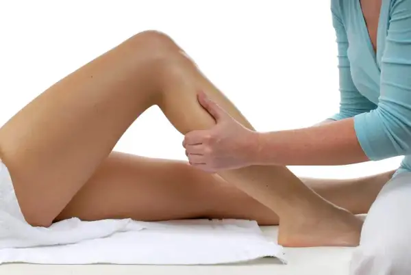 Mani esperte eseguono un massaggio gambe in gravidanza per alleviare la tensione e favorire il benessere.